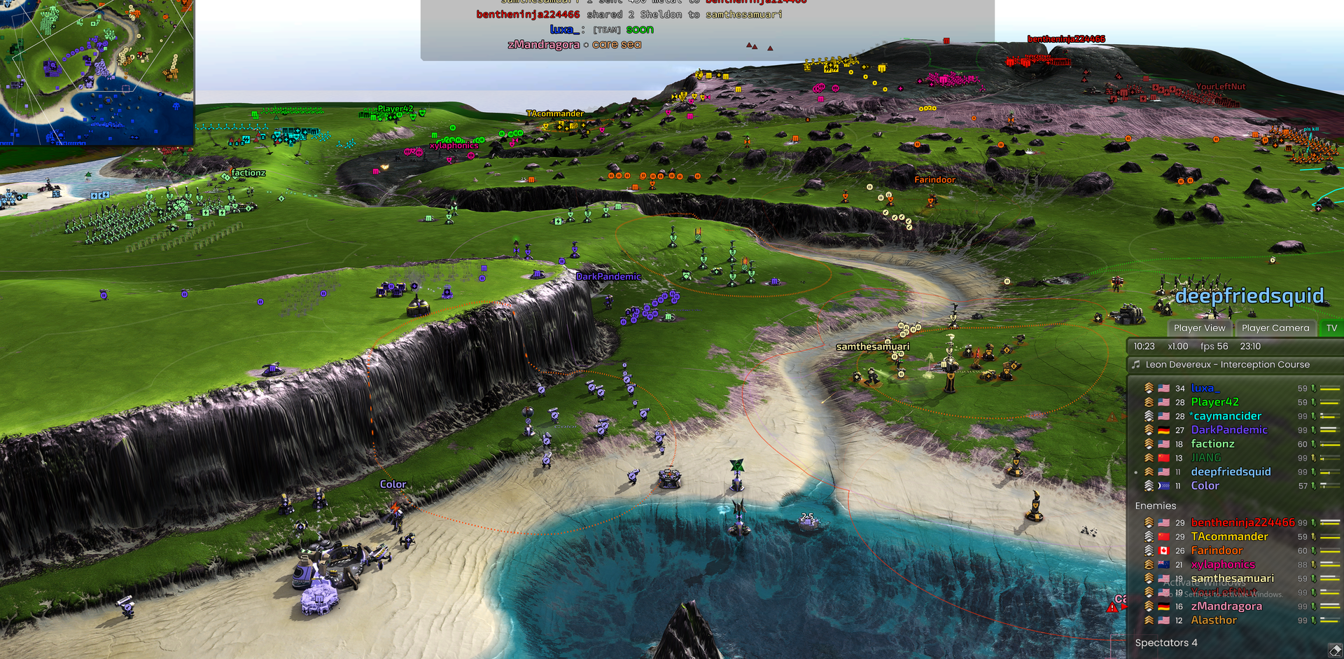 A full 16-player match on Pyroclast, seen from a low angle: armies spread across green plateaus above sheer black cliffs, with a sandy beach and bay in the foreground
